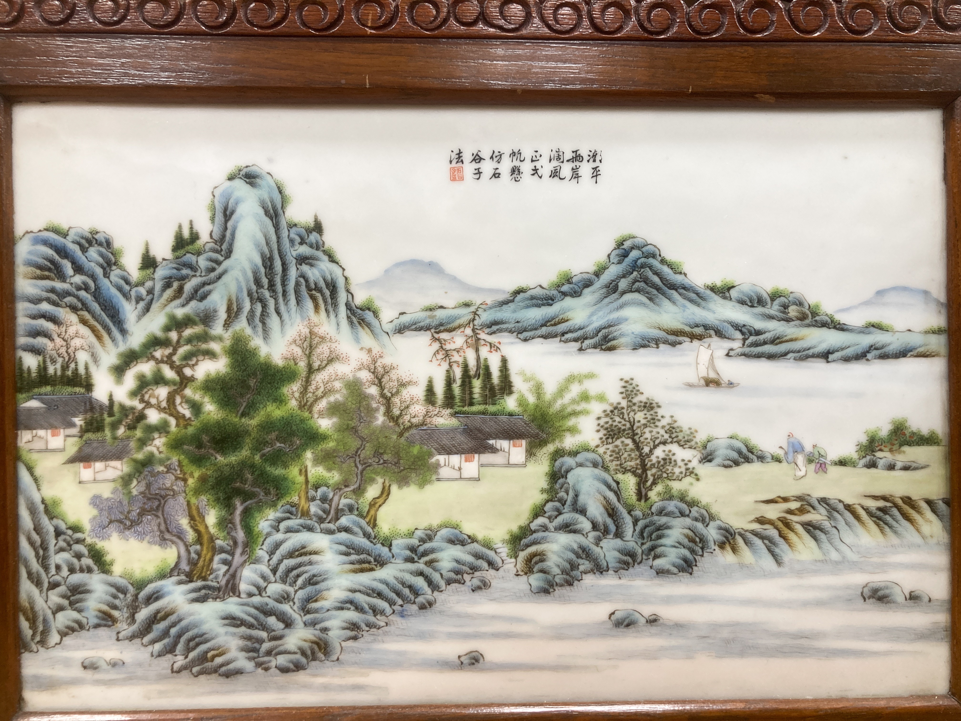 A 20th century Republic period porcelain plaque decorated in coloured enamels with landscape scene, inscription mark 24 x 38cm in carved frame